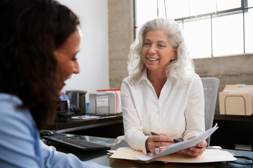 Senior professional woman meeting in office with young woman